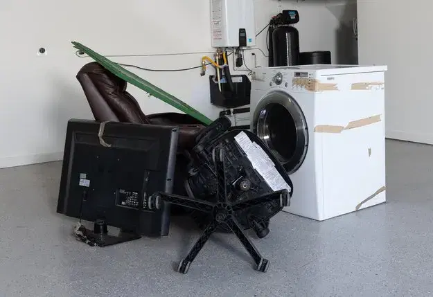 Junk sitting in a garage waiting for eco-friendly same-day junk removal from Junk.com